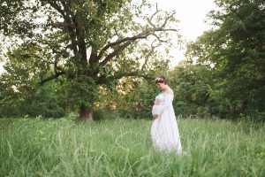 Maternity session in field with floral crown and white gown northwest arkansas pregnancy photographer Bentonville Rogers Fayetteville AR - Erica Kirby Photography