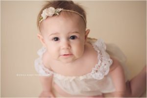 9 Month old baby girl milestone session in Bentonville AR photography studio with creams and purples | Erica Kirby Photography - NWA Baby Photographer