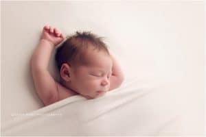 NWA Newborn Photographers | Baby boy newborn photography session in Bentonville Arkansas | baby on cream background unposed