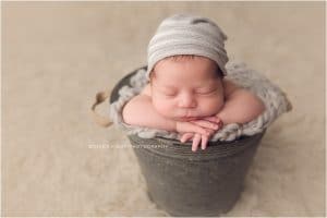 Baby boy newborn photography session in Bentonville Arkansas | newborn baby boy posed in metal bucket with slouch hat