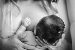 Mother breastfeeding her three month old baby in natural window light | Erica Kirby Photography