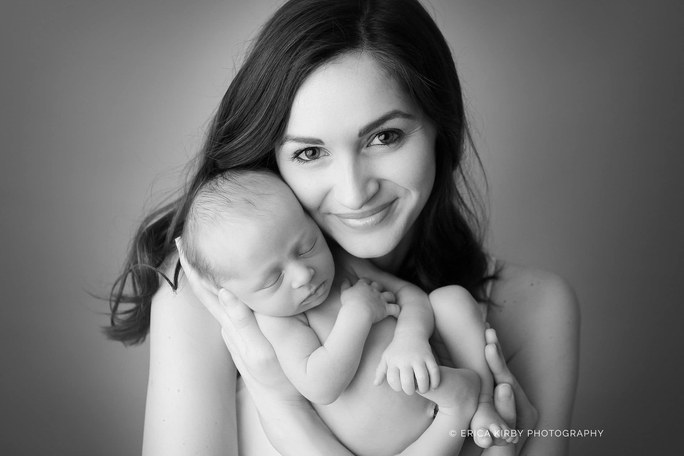 Newborn Photographers NWA | newborn baby boy in Rogers Arkansas snuggled with mom in studio photo session | Erica Kirby Photography