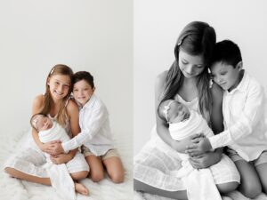 black and white photo of newborn baby with older siblings smiling during photoshoot in northwest arkansas