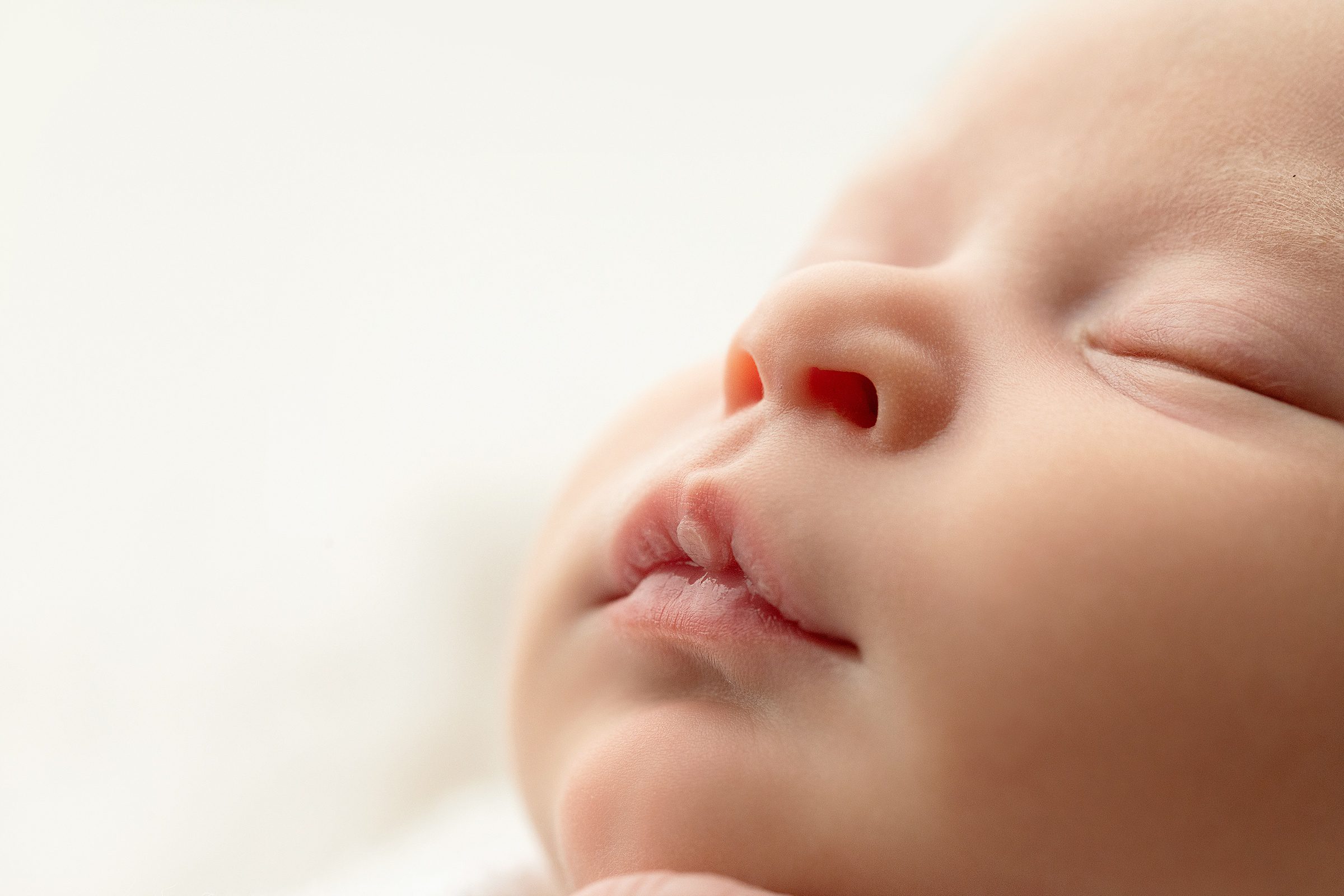 closeup of newborn baby lips and profile during photography session in Bentonville Arkansas studio